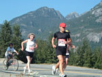 Runners and wheelchair racers against the scenic mountain backdrop