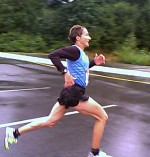 Lucy Smith smiling as she approaches the finish line